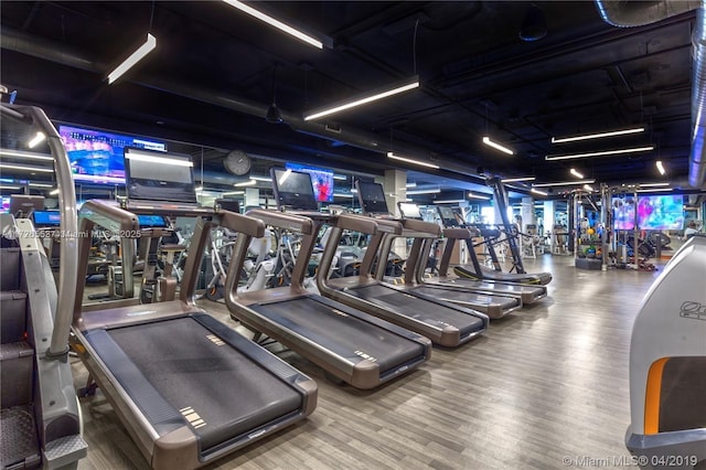 workout area with wood-type flooring