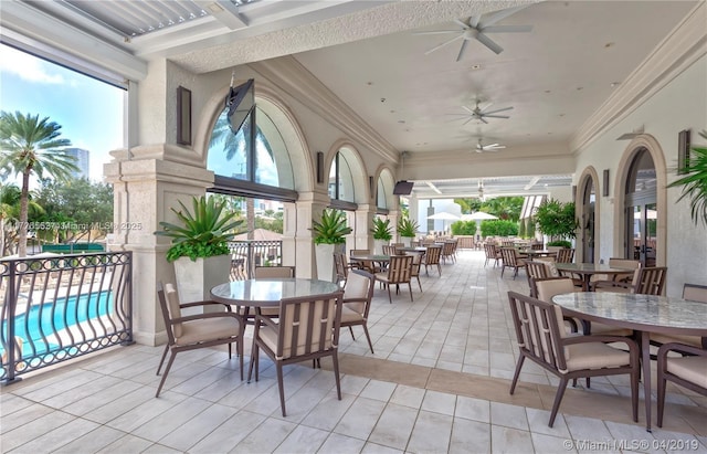 sunroom / solarium with ceiling fan