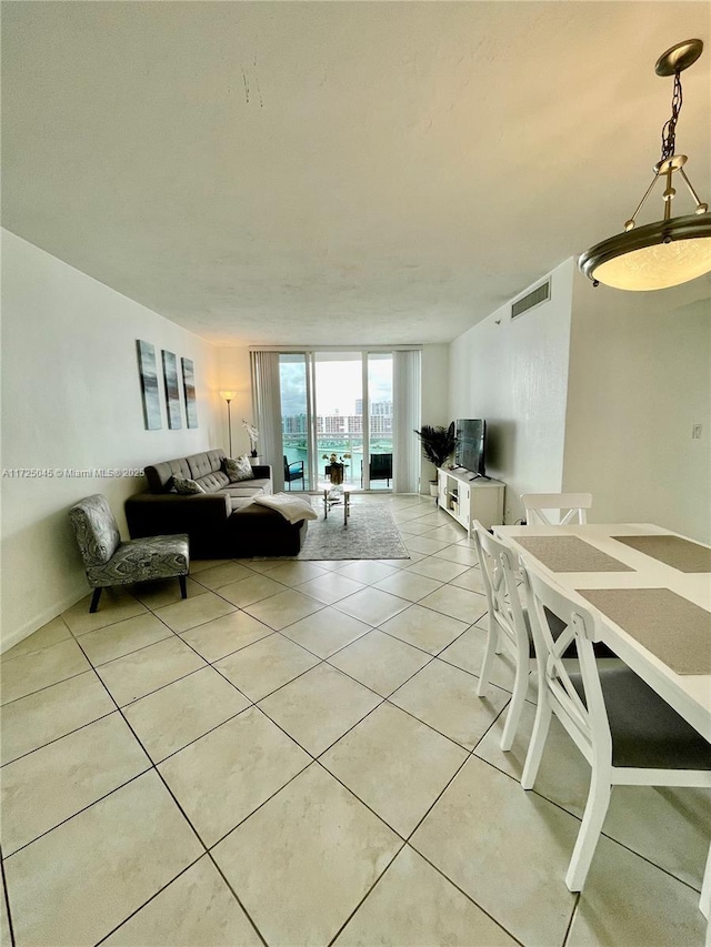 living area featuring visible vents and light tile patterned flooring