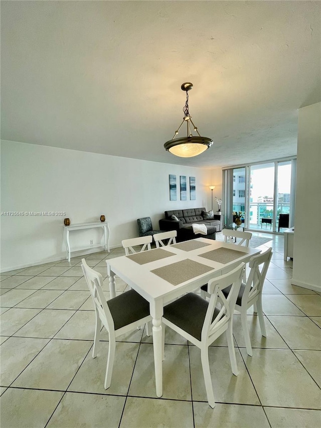 dining area with baseboards and light tile patterned floors