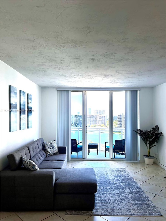 living room with a wall of windows, a view of city, and tile patterned flooring