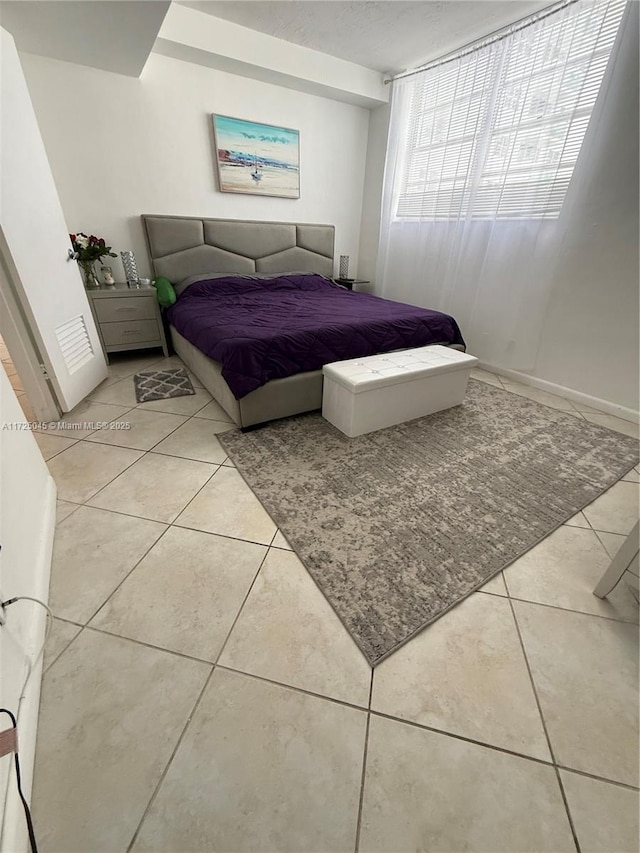 bedroom featuring a textured ceiling and light tile patterned floors