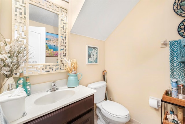 bathroom featuring toilet, a textured ceiling, lofted ceiling, and vanity