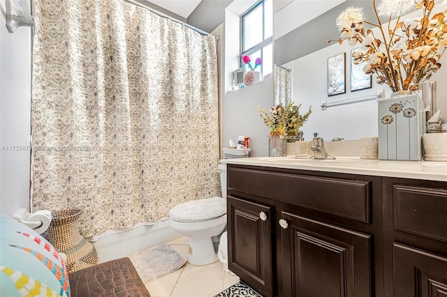 full bathroom featuring shower / bath combo with shower curtain, toilet, vanity, and tile patterned flooring