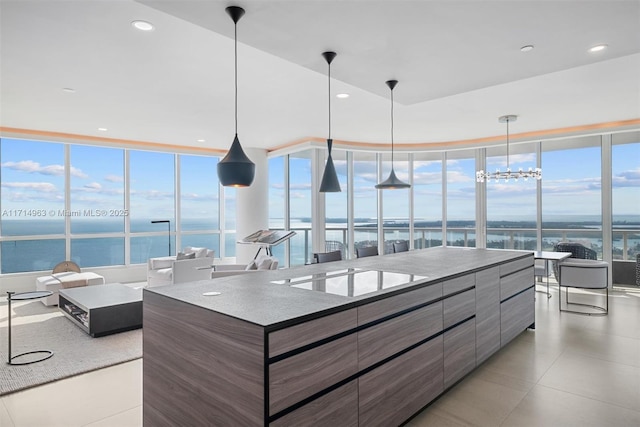 100 S Pointe Dr Unit 3203, Miami Beach, FL 33139 - kitchen with stovetop, modern cabinets, a water view, hanging light fixtures, and recessed lighting