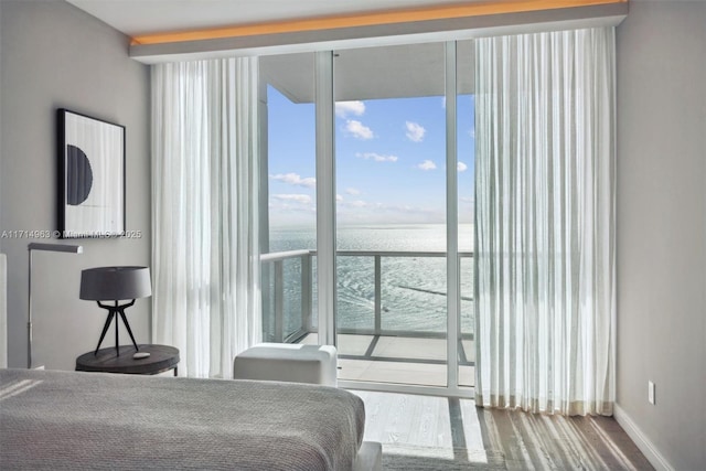 100 S Pointe Dr Unit 3203, Miami Beach, FL 33139 - bedroom featuring a water view, wood finished floors, expansive windows, and baseboards