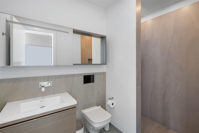 100 S Pointe Dr Unit 3203, Miami Beach, FL 33139 - bathroom featuring vanity, tile walls, toilet, and a shower