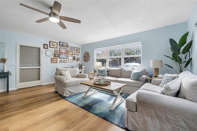 living room featuring hardwood / wood-style flooring and ceiling fan