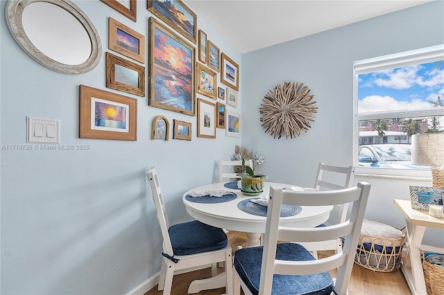 dining area featuring wood finished floors and baseboards