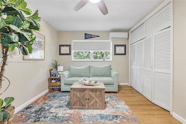 3209 Colony Club Rd Unit 1-W, Pompano Beach, FL 33062 - living room featuring a wall mounted air conditioner, ceiling fan, baseboards, and light wood finished floors