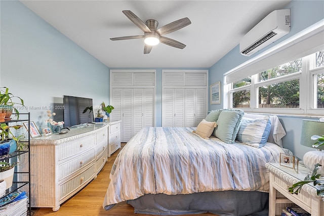 3209 Colony Club Rd Unit 1-W, Pompano Beach, FL 33062 - bedroom with a wall unit AC, two closets, light wood-style flooring, and a ceiling fan
