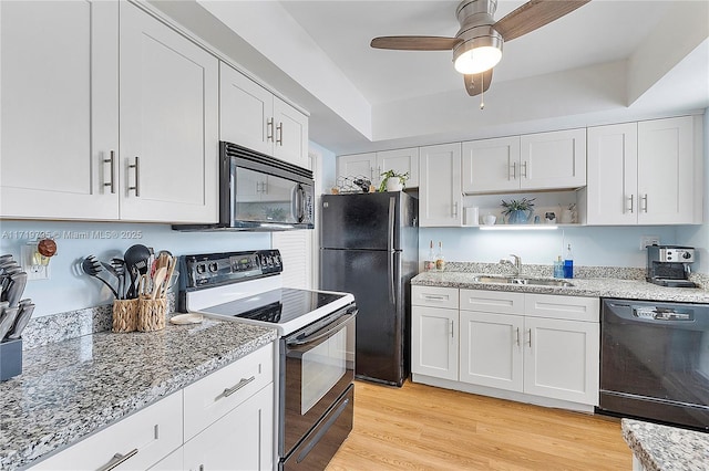 3209 Colony Club Rd Unit 1-W, Pompano Beach, FL 33062 - kitchen with black appliances, a sink, white cabinets, and light stone countertops