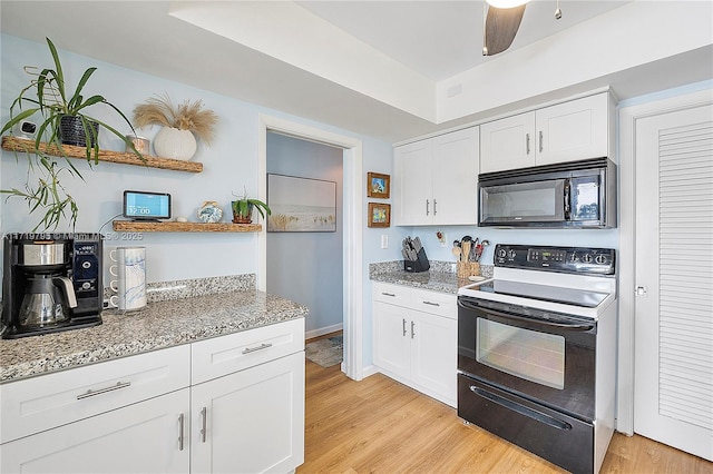 3209 Colony Club Rd Unit 1-W, Pompano Beach, FL 33062 - kitchen featuring black microwave, electric range, open shelves, white cabinetry, and light wood-type flooring