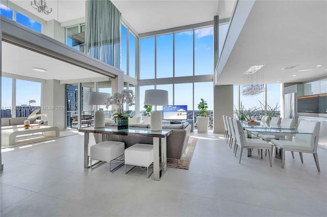 dining area featuring a chandelier and a high ceiling