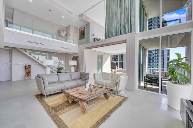 tiled living room featuring a towering ceiling