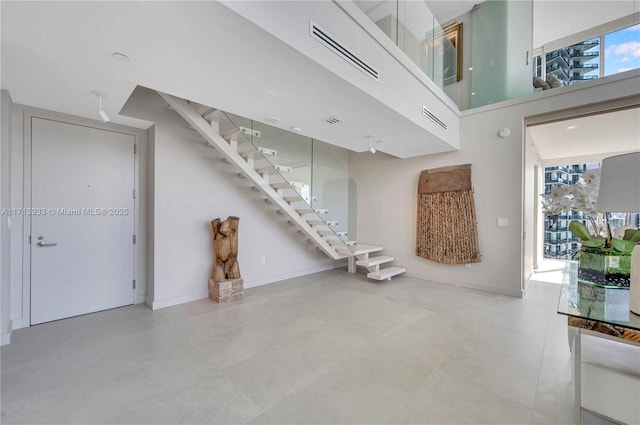 unfurnished living room with a towering ceiling