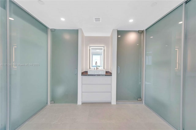 bathroom with walk in shower and vanity