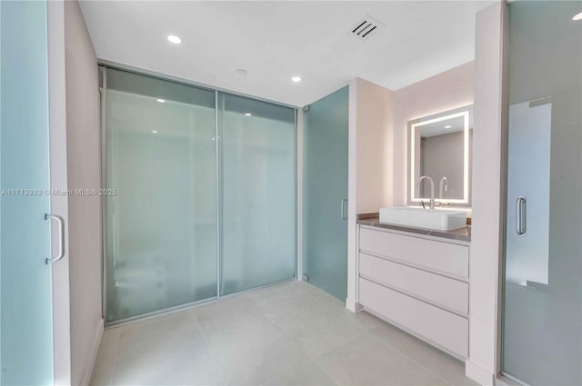 bathroom with vanity, tile patterned flooring, and an enclosed shower