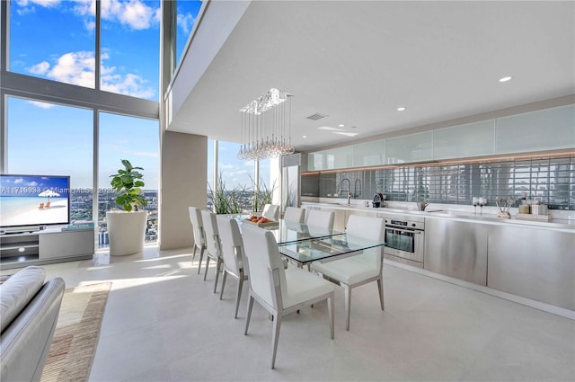 dining area featuring plenty of natural light and a notable chandelier