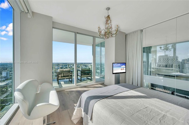 bedroom with a notable chandelier and light hardwood / wood-style floors