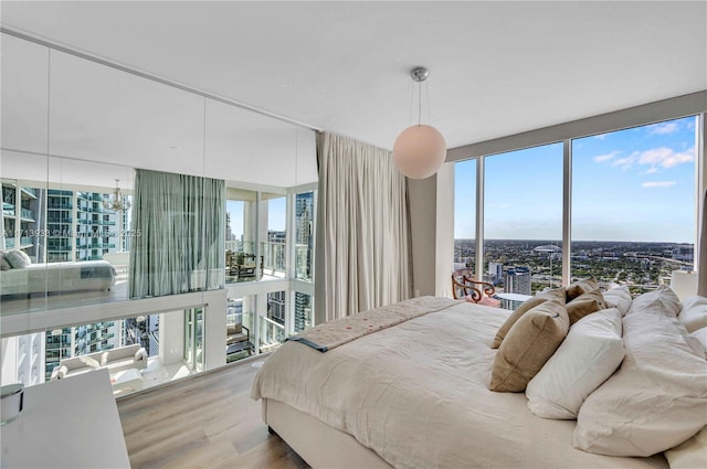 bedroom featuring an inviting chandelier and hardwood / wood-style floors