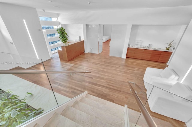 staircase with hardwood / wood-style floors