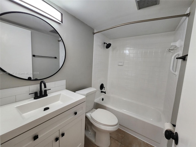 bathroom with visible vents, toilet, tile patterned flooring, vanity, and washtub / shower combination