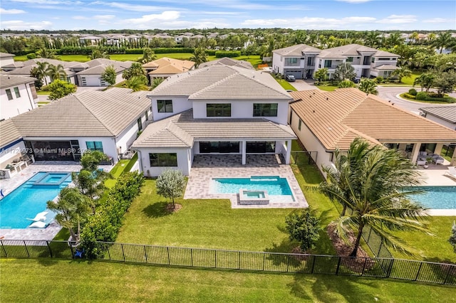 view of swimming pool featuring an in ground hot tub, a patio area, and a lawn