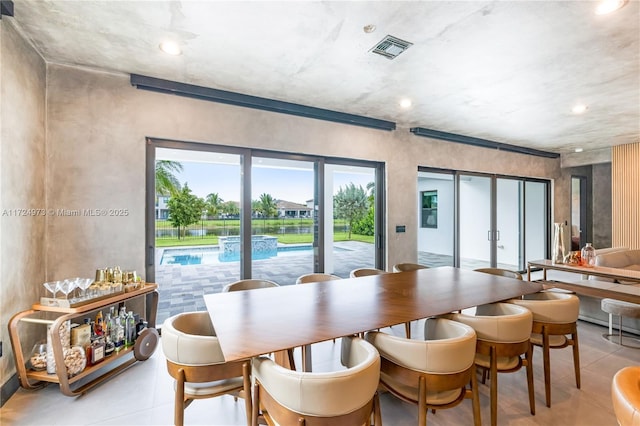 tiled dining space featuring french doors