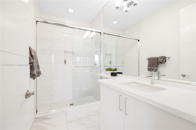 bathroom featuring vanity and a shower with shower door