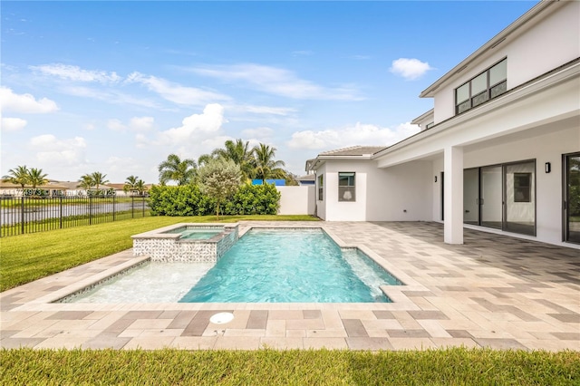 view of swimming pool featuring an in ground hot tub, a yard, and a patio area