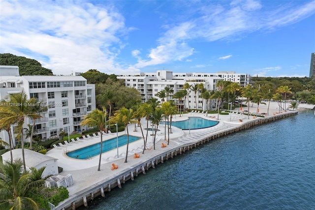 view of swimming pool with a water view and a patio