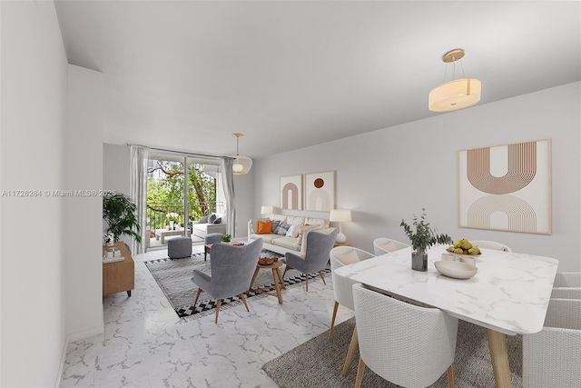 dining area featuring marble finish floor