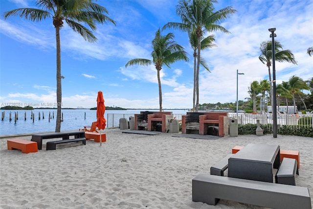 view of home's community with a boat dock and a water view