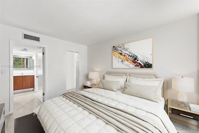 bedroom with visible vents and ensuite bathroom