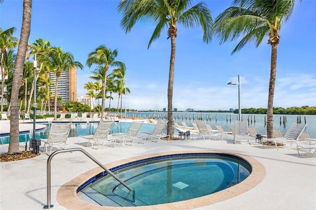 community pool with a patio and a community hot tub