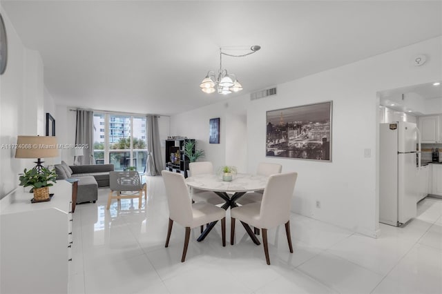 tiled dining area with expansive windows and a chandelier