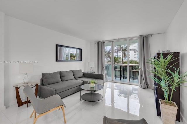 living room with light tile patterned floors and a wall of windows