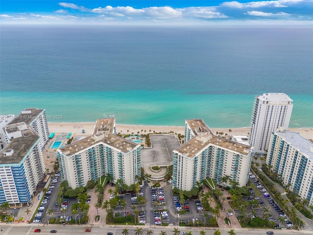 birds eye view of property with a water view and a view of the beach