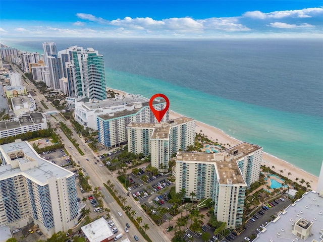 drone / aerial view with a water view and a beach view