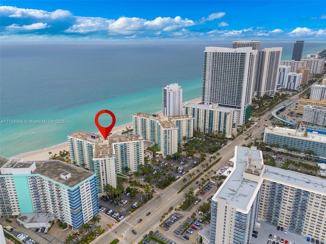 birds eye view of property featuring a water view and a view of the beach