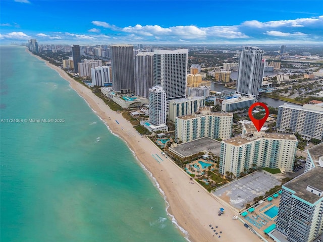 birds eye view of property with a water view and a view of the beach