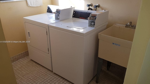 laundry area with washing machine and dryer and sink