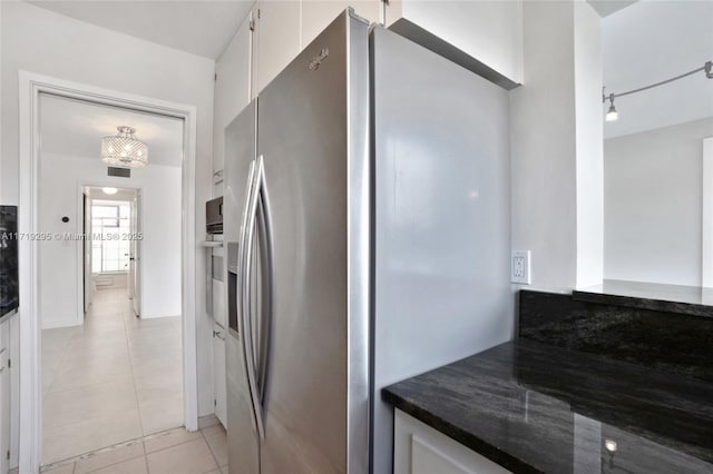 kitchen with visible vents, dark countertops, stainless steel appliances, white cabinetry, and light tile patterned flooring