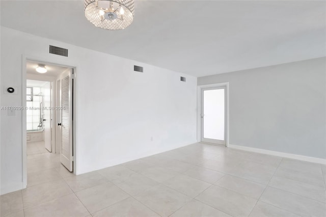 180 Isle Of Venice Dr Unit 105, Fort Lauderdale, FL 33301 - spare room featuring light tile patterned floors, a chandelier, and visible vents