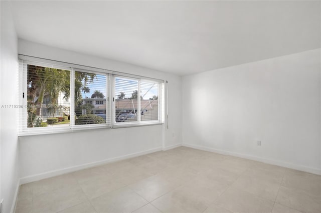 unfurnished room featuring baseboards