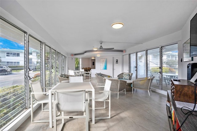 sunroom featuring a ceiling fan