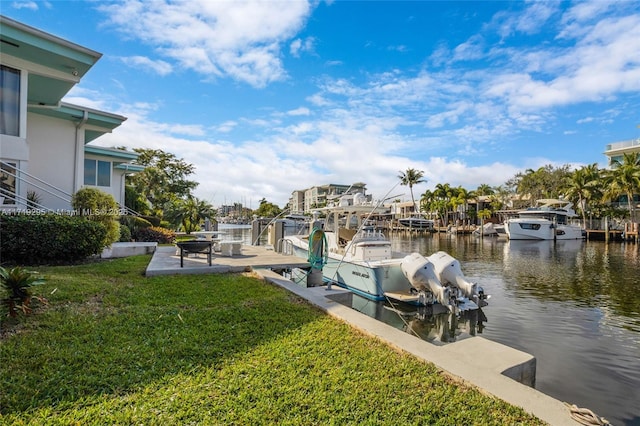 dock area with a yard, a water view, and boat lift