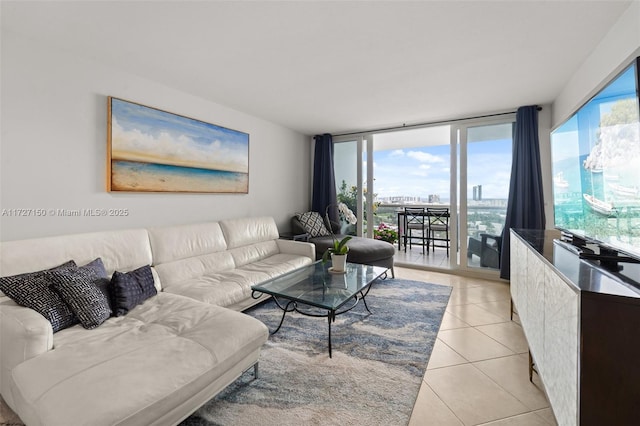 living room featuring a wall of windows and light tile patterned flooring