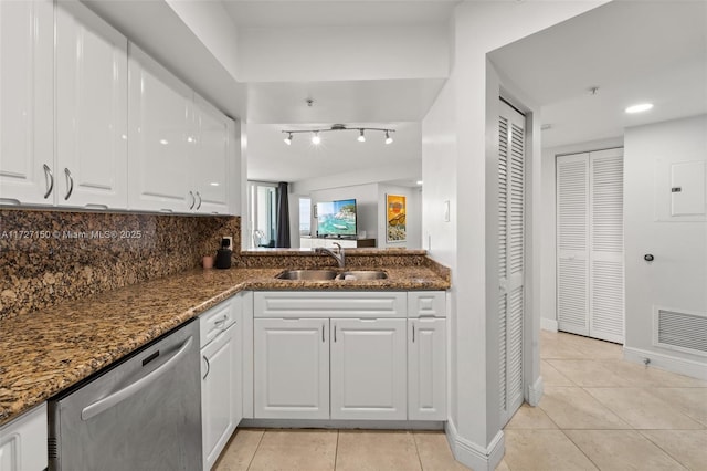 kitchen with stainless steel dishwasher, white cabinets, and sink